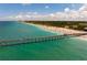 Scenic beach view with pier and turquoise water at 554 Fallbrook Dr, Venice, FL 34292