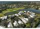 Aerial view of luxury homes near golf course and lake at 554 Fallbrook Dr, Venice, FL 34292