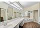 Spacious bathroom with double sinks, a large bathtub, and updated flooring at 554 Fallbrook Dr, Venice, FL 34292