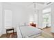 Bright bedroom with queen bed, ensuite access, and window seating at 554 Fallbrook Dr, Venice, FL 34292