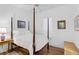 Cozy bedroom with a wooden four-poster bed and ample natural light at 554 Fallbrook Dr, Venice, FL 34292