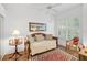 Comfortable bedroom with daybed, window seating, and a ceiling fan at 554 Fallbrook Dr, Venice, FL 34292