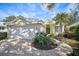Charming yellow house with a white garage door and landscaped yard at 554 Fallbrook Dr, Venice, FL 34292