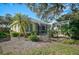 Charming house with a screened patio and pergola in the backyard at 554 Fallbrook Dr, Venice, FL 34292