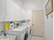Laundry room with washer, dryer, cabinets, and extra storage at 554 Fallbrook Dr, Venice, FL 34292