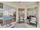 Bright sunroom with wicker furniture and access to the backyard at 554 Fallbrook Dr, Venice, FL 34292