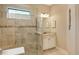 Bathroom with a walk-in shower, tiled walls, and vanity at 5593 Piccolo St, Nokomis, FL 34275