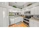 White kitchen cabinets with stainless steel appliances at 5933 Clubside Dr # 7640, Sarasota, FL 34243