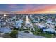 Aerial view of home at sunset on the waterfront at 634 Key Royale Dr, Holmes Beach, FL 34217