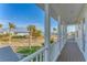 Balcony overlooking the water with white railing and wooden flooring at 634 Key Royale Dr, Holmes Beach, FL 34217
