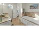 Elegant bathroom with double vanity and a soaking tub at 634 Key Royale Dr, Holmes Beach, FL 34217