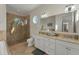 Bathroom with double vanity and walk-in shower at 634 Key Royale Dr, Holmes Beach, FL 34217
