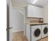 Laundry room with white cabinets, washer, and dryer at 634 Key Royale Dr, Holmes Beach, FL 34217