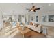 Bright living room with comfy seating, large windows, and open floor plan at 634 Key Royale Dr, Holmes Beach, FL 34217