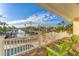 Relaxing patio overlooking the water with green chairs and a pool at 634 Key Royale Dr, Holmes Beach, FL 34217