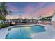 Freeform swimming pool with canal views at sunset at 634 Key Royale Dr, Holmes Beach, FL 34217