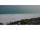 Beachfront aerial view showcasing coastline and parking at 6424 Midnight Pass Rd # 12A, Sarasota, FL 34242