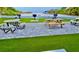 Beachfront BBQ area with picnic tables and grills at 6424 Midnight Pass Rd # 12A, Sarasota, FL 34242