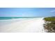 Scenic beach view with white sand and gentle waves at 6424 Midnight Pass Rd # 12A, Sarasota, FL 34242