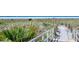Beach access pathway with boardwalk and dune vegetation at 6424 Midnight Pass Rd # 12A, Sarasota, FL 34242