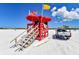 Beachfront view with lifeguard stand and beach patrol vehicle at 6424 Midnight Pass Rd # 12A, Sarasota, FL 34242