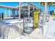 Beachfront pavilion with shaded seating and informational kiosk at 6424 Midnight Pass Rd # 12A, Sarasota, FL 34242