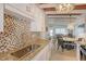 Modern kitchen with granite countertops and mosaic backsplash at 6424 Midnight Pass Rd # 12A, Sarasota, FL 34242