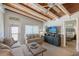 Living room with wood ceilings, comfy sofas, and large TV at 6424 Midnight Pass Rd # 12A, Sarasota, FL 34242