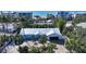 Coastal home with metal roof, driveway, and ocean views at 6501 Gulf Of Mexico Dr, Longboat Key, FL 34228