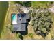 Aerial view of a home next to a lake, featuring a private pool and ample outdoor space at 6706 88Th E St, Bradenton, FL 34202