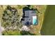 Aerial view of a home featuring a pool, mature trees, and lake access at 6706 88Th E St, Bradenton, FL 34202