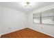 Well-lit bedroom with wood floors and a window with blinds at 6706 88Th E St, Bradenton, FL 34202