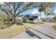 Two-story house with white exterior, dark gray accents, and a long driveway at 6706 88Th E St, Bradenton, FL 34202