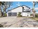 White two-story house with a dark gray garage door and side yard at 6706 88Th E St, Bradenton, FL 34202