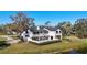 Exterior view of a two-story home with a balcony overlooking a beautifully landscaped yard at 6706 88Th E St, Bradenton, FL 34202