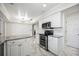 Modern kitchen features white cabinets, granite countertops, and stainless steel appliances at 6706 88Th E St, Bradenton, FL 34202