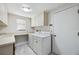 Bright laundry room with washer, dryer, and storage cabinets at 6706 88Th E St, Bradenton, FL 34202