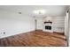 Living room with fireplace, built-in shelving and hardwood floors at 6706 88Th E St, Bradenton, FL 34202