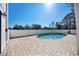 Inviting backyard pool area featuring a brick patio, white fence, perfect for outdoor relaxation and entertainment at 6706 88Th E St, Bradenton, FL 34202