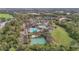 Aerial view of a pool, community center, and basketball court nestled among trees and lakes in a Gathering-friendly community at 6815 Turnberry Isle Ct, Lakewood Ranch, FL 34202