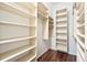 Spacious walk-in closet with custom shelving and wood-look tile flooring at 6815 Turnberry Isle Ct, Lakewood Ranch, FL 34202