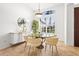 Bright dining room features a glass table, stylish chairs, and large window, perfect for Gathering meals at 6815 Turnberry Isle Ct, Lakewood Ranch, FL 34202