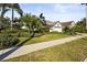 Inviting home exterior with manicured lawn, lush foliage, and a convenient two-car garage enhancing curb appeal at 6815 Turnberry Isle Ct, Lakewood Ranch, FL 34202