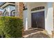 An inviting double front door with brick accents and manicured hedges at 6815 Turnberry Isle Ct, Lakewood Ranch, FL 34202