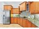 Bright kitchen featuring custom wood cabinets, granite countertops, and stainless steel appliances at 6815 Turnberry Isle Ct, Lakewood Ranch, FL 34202
