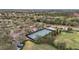 Aerial view of pickleball courts surrounded by lush greenery, trees, and walking paths in a friendly neighborhood setting at 6815 Turnberry Isle Ct, Lakewood Ranch, FL 34202