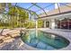 Screened-in pool and spa with lovely water feature on a brick-paved deck at 6815 Turnberry Isle Ct, Lakewood Ranch, FL 34202