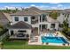 A luxury backyard featuring a beautiful pool, patio, and outdoor seating area at 696 Regatta Way, Bradenton, FL 34208
