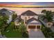 Luxury waterfront home with a two car garage and manicured landscaping at 696 Regatta Way, Bradenton, FL 34208