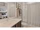 Clean bathroom with tub shower, vanity, and neutral tile at 696 Regatta Way, Bradenton, FL 34208